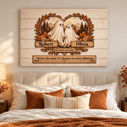 Personalized wooden wall art hanging above a bed, featuring two ghost figures with a heart-shaped wreath, pumpkins, trees, and custom names Robert and Olivia with a memorial-style quote.