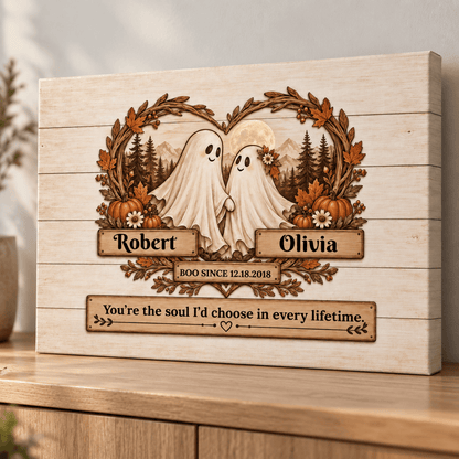 Personalized wooden Halloween wall art featuring two ghost figures inside a wreath with pumpkins, mountains, and trees, with custom names Robert and Olivia and a quote below, shown on a wooden surface.