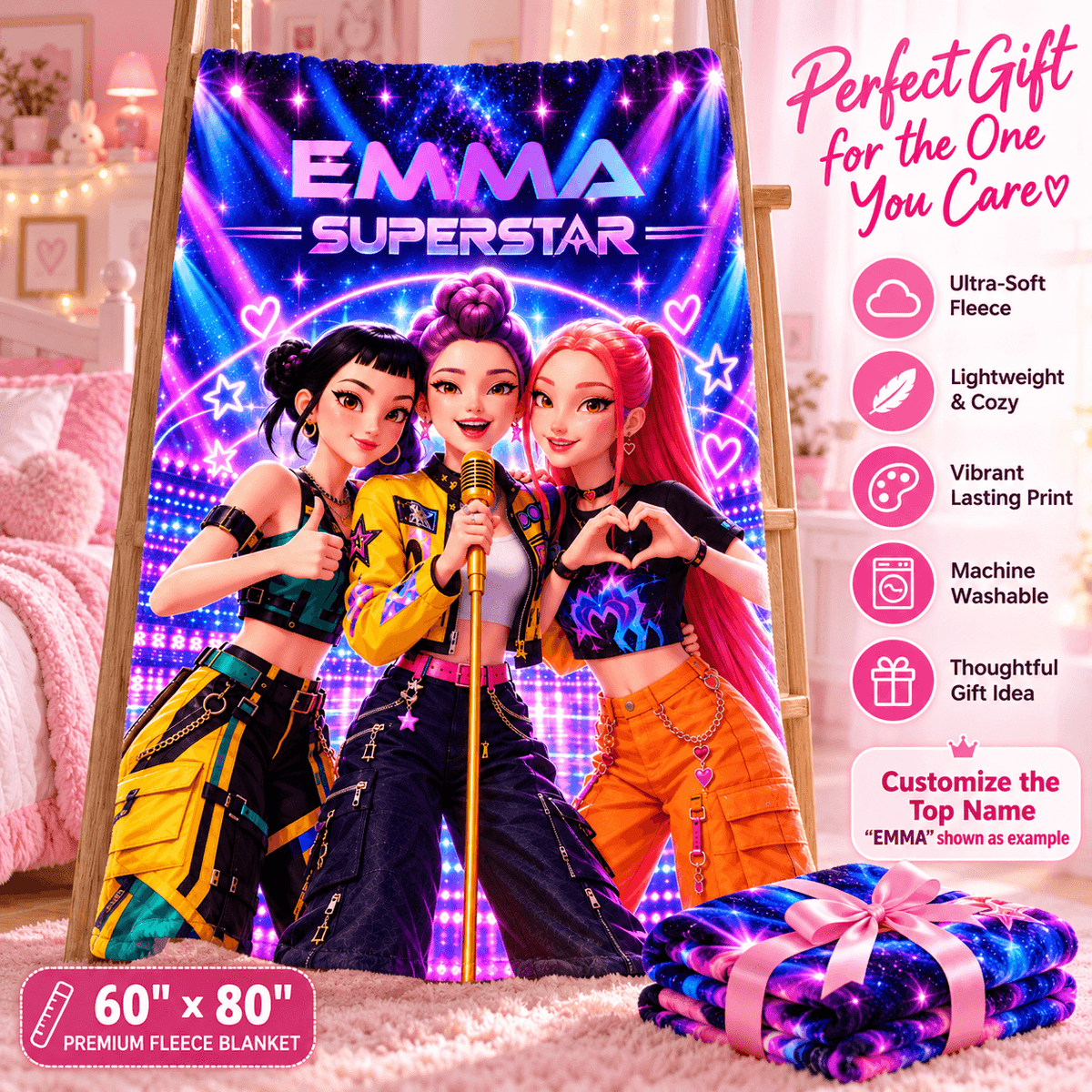 A custom fleece blanket featuring three cartoon-style rock stars with the text 'EMMA SUPERSTAR' is displayed on an easel in a bedroom setting. A folded matching blanket with a pink ribbon is shown in the foreground, and a list of product features is displayed on the right side.