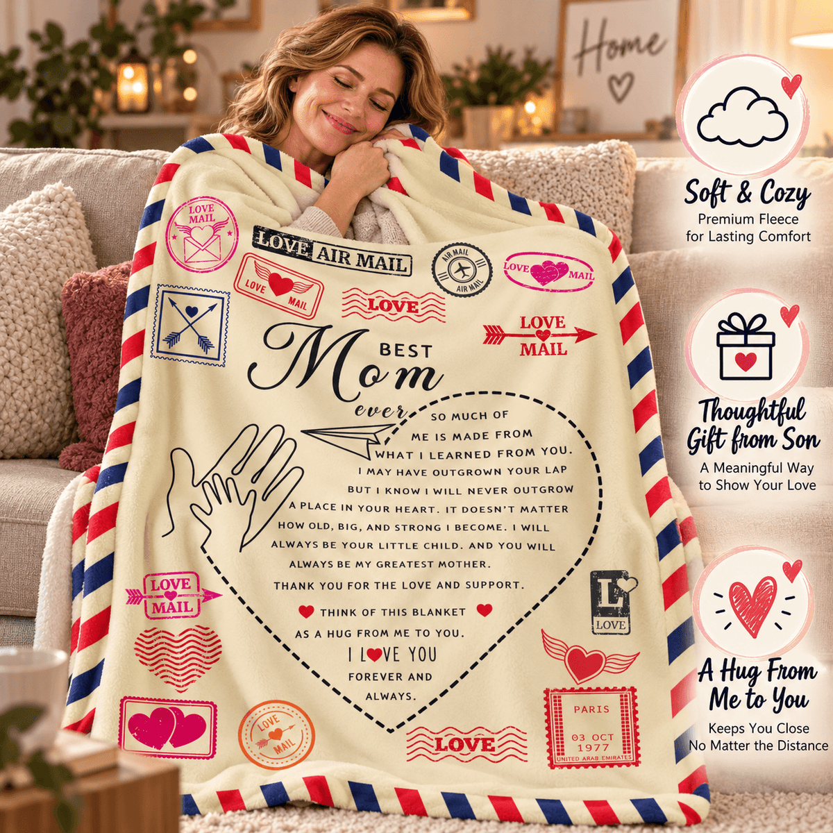 A woman sits on a couch wrapped in a cream fleece blanket printed with vintage-style airmail stamps, hearts, and a large message for Mom. The scene is warmly lit, with a product infographic overlay on the right side highlighting softness, thoughtful gift value, and long-distance comfort.