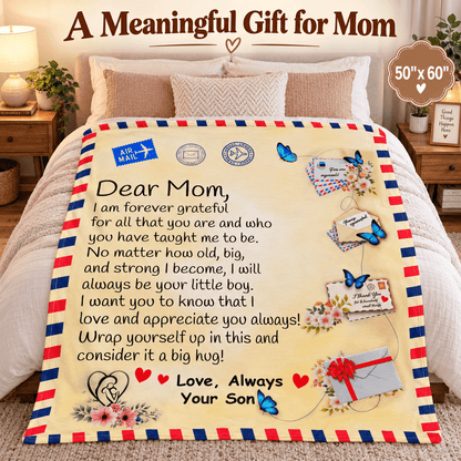 A personalized fleece blanket with a cream background, printed with a heartfelt letter to Mom, decorated with red and blue striped borders, butterflies, envelopes, and hearts. The blanket is displayed on a bed in a cozy bedroom setting, with promotional text overlays at the top.