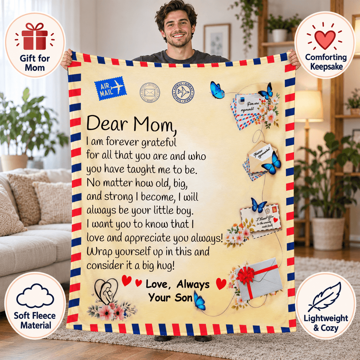 A man holds up a large fleece blanket with a printed heartfelt letter to Mom, styled like an airmail envelope with red, white, and blue borders and decorative graphics. The scene is set in a cozy living room, with circular callout badges around the edges highlighting gift, comforting keepsake, soft fleece material, and lightweight cozy qualities.