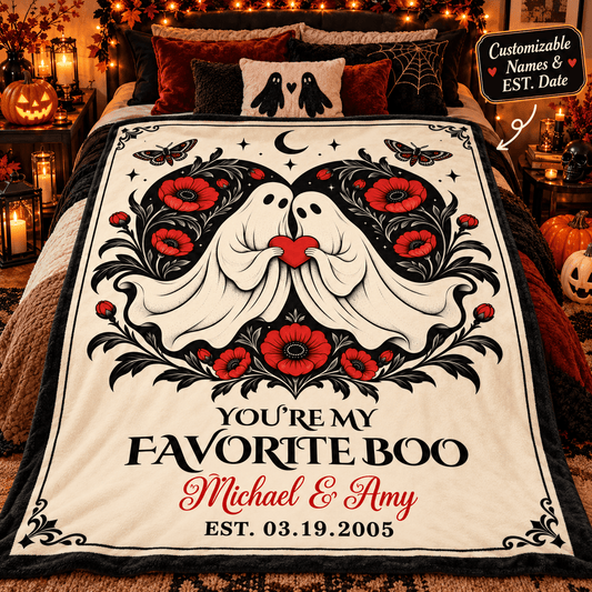 A personalized Halloween-themed blanket draped over a bed in a cozy, decorated bedroom. The blanket features a cream background with a black and white ghost design kissing, surrounded by red flowers and black leaves, with the text 'YOU'RE MY FAVORITE BOO Michael & Amy EST.