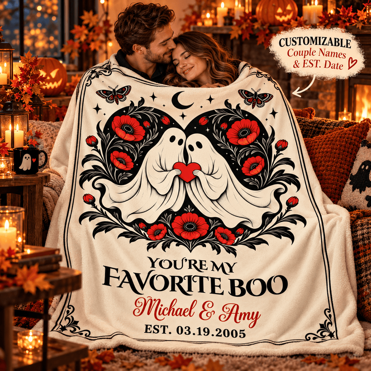 A couple wrapped in a cozy fleece blanket featuring a Halloween-themed design with two ghosts, red flowers, black scrollwork, and the text 'YOU'RE MY FAVORITE BOO Michael & Amy EST. 03.