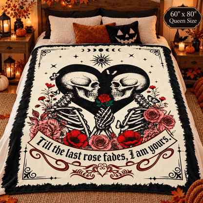 A gothic-themed bedding set featuring a printed blanket with two kissing skeletons, roses, stars, and the quote 'Till the last rose fades, I am yours,' shown on a bed in a styled bedroom.