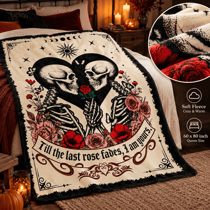 A decorative blanket draped over a bed in a cozy bedroom scene, featuring two facing skeletons, roses, moon phases, and the text 'Till the last rose fades, I am yours.' An inset circle shows close-up texture details, and a side panel lists soft fleece, cozy warmth, and 60 x 80 inch queen size.