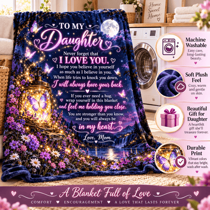 A dark purple and blue fleece blanket with a glowing floral night scene and a large heart-shaped moon, draped over a bed in a bedroom. The blanket features a sentimental message for a daughter.