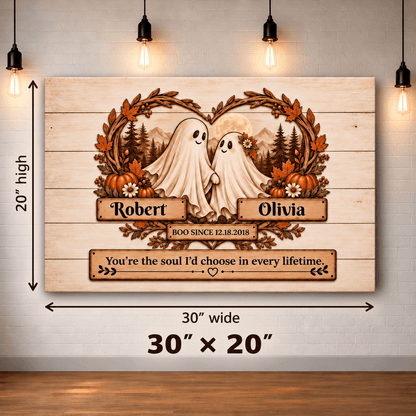 Personalized wooden Halloween wall art shown hanging on a white brick wall, with dimension arrows and text indicating 30 inches wide by 20 inches high. The print features two white ghosts, autumn leaves, pumpkins, mountains, and custom names Robert and Olivia with a quote at the bottom.