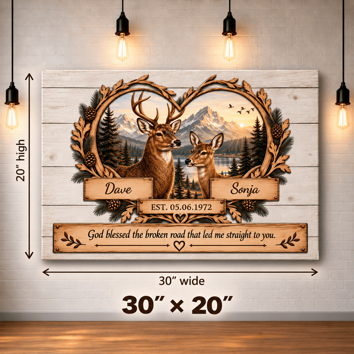Personalized wooden wall art panel shown hanging on a light wood wall with hanging bulbs. The panel features a deer and fox in front of a mountain lake landscape, framed by a leafy border, with the names Dave and Sonja and a memorial date.