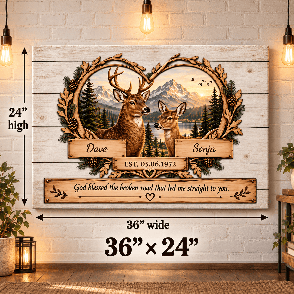 Personalized rustic wood sign featuring two deer in front of mountains and a lake, with the names Dave and Sonja and a memorial date. The sign includes dimension callouts showing 36 inches wide by 24 inches high, photographed against a white wood plank wall with hanging lights and plants.